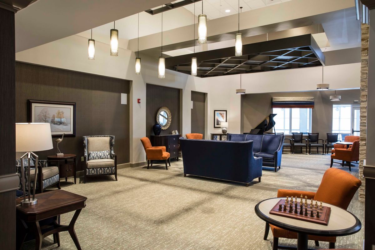A modern lobby with elegant seating and a chess board.