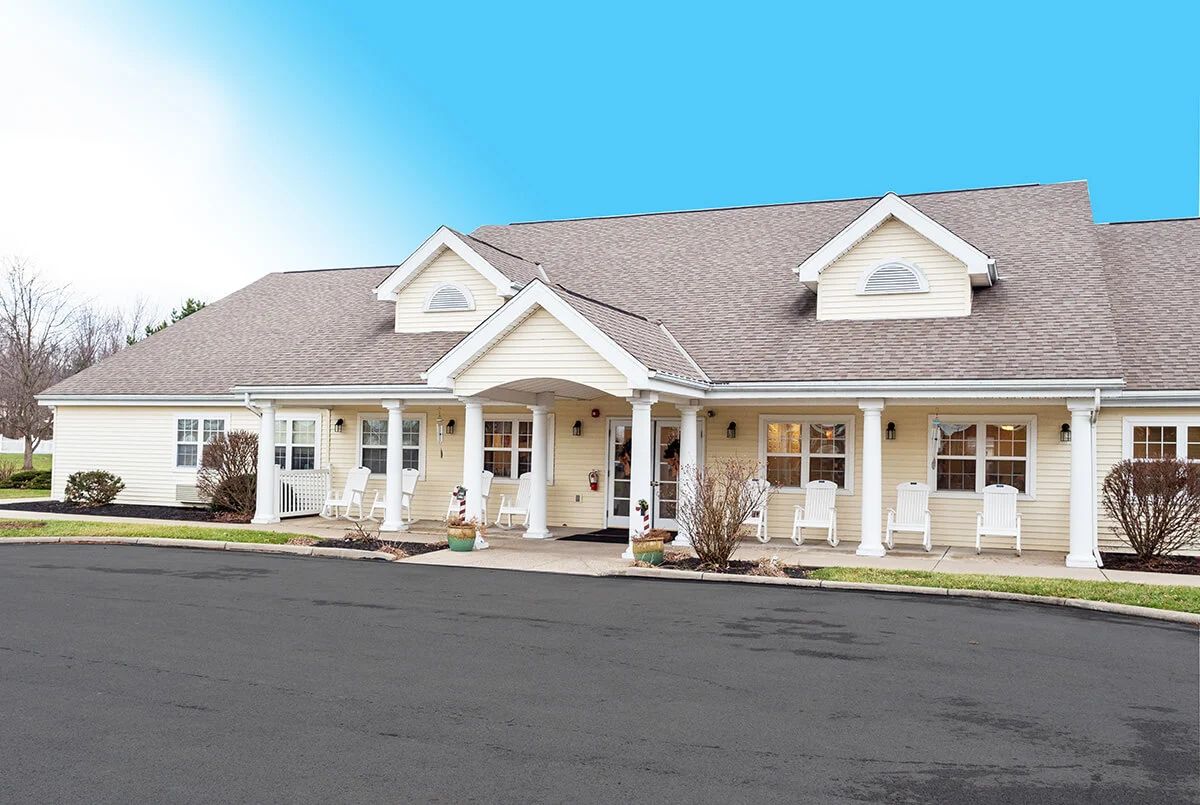An exterior view of a residential building with a pitched roof and covered porch.