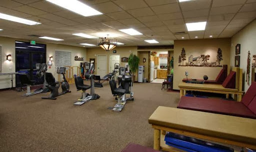 A spacious fitness center equipped with exercise machines and rehabilitation areas.