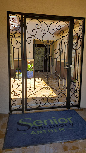 A beautifully designed decorative iron gate welcomes guests to the entrance of a home.