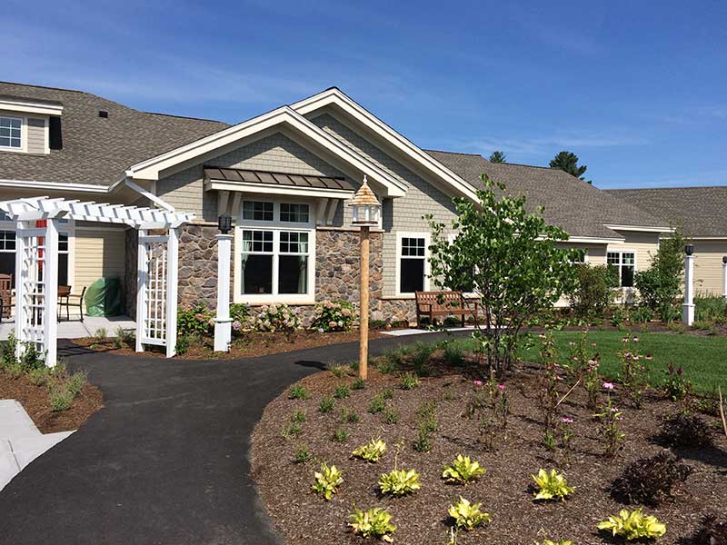 A suburban house with well-maintained landscaping and a garden.
