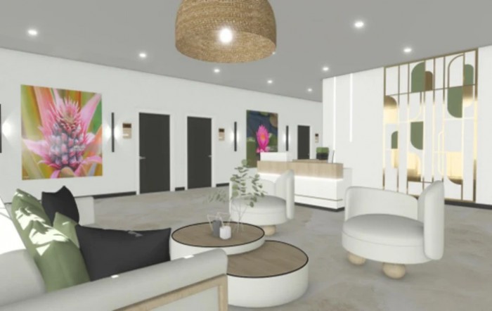 A modern and minimalist lobby area with comfortable seating, a reception desk, and decorative artwork.