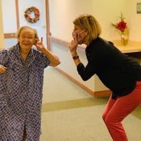 Two people playing and having fun indoors, sharing a joyful moment.