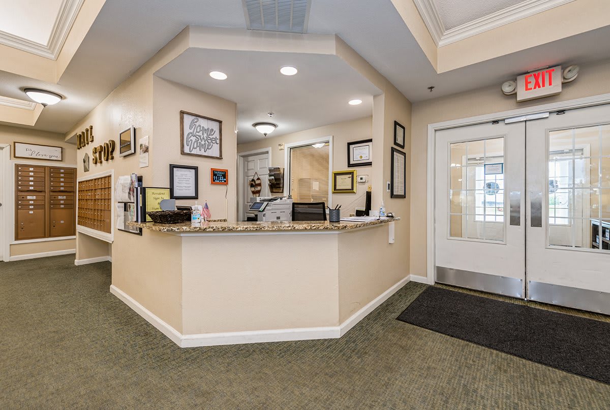 A well-lit reception area with a desk and wall decorations.
