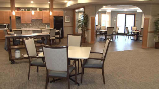 A spacious and inviting dining area featuring modern furniture and ample natural light.