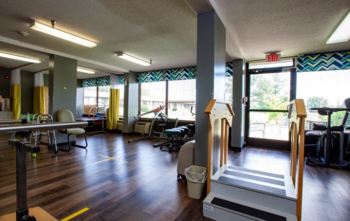 An interior view of a rehabilitation clinic with exercise equipment.
