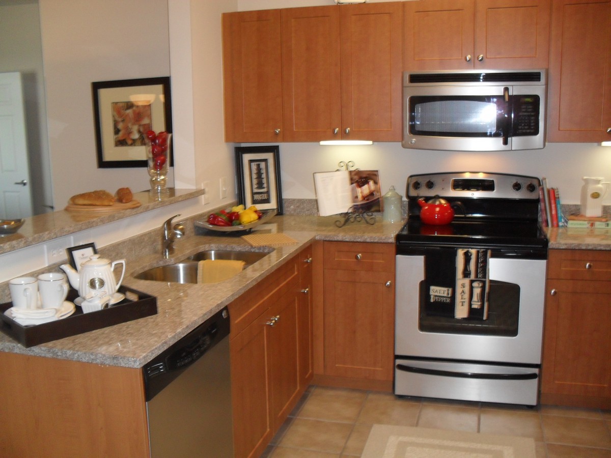 A modern kitchen with wooden cabinetry and stainless steel appliances.