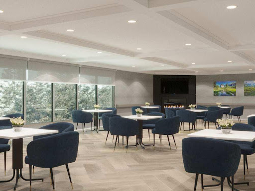 A modern dining area featuring elegant blue chairs and a well-lit ambiance.