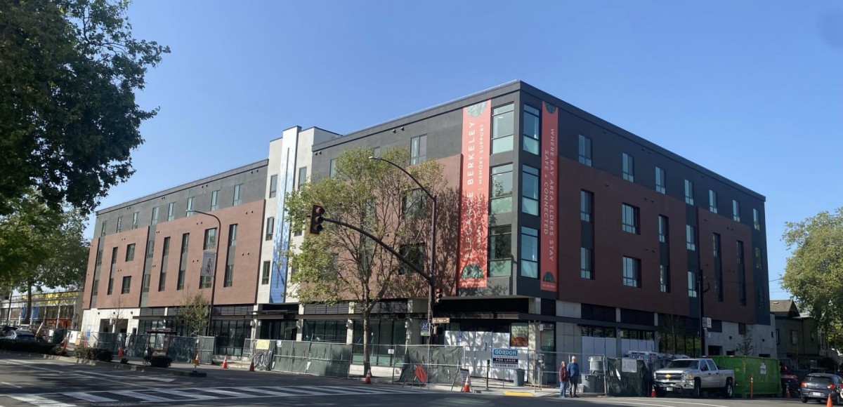 A modern multi-story building under construction on a city street.
