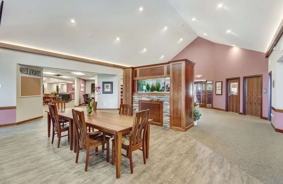 A spacious dining area with modern wooden furniture and ambient lighting.