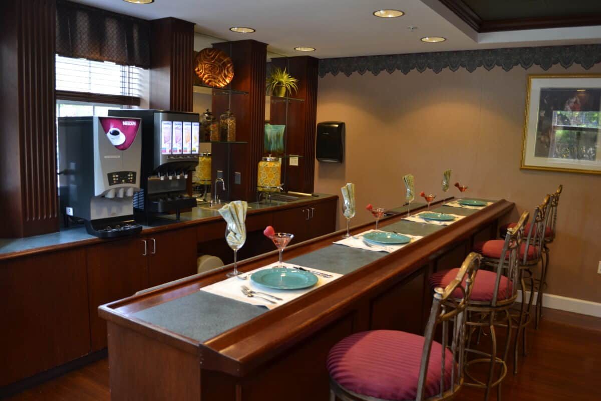 A cozy restaurant bar with neatly set tables and stylish seating.