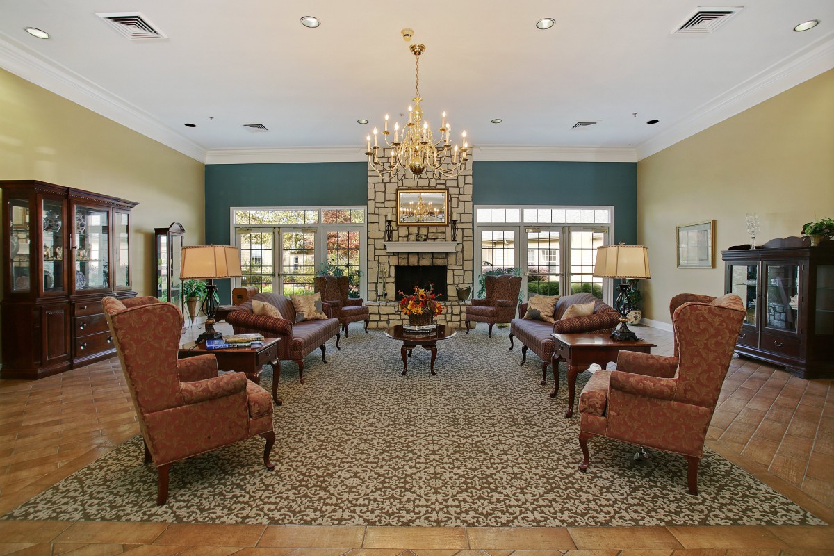 Elegant living room with a chandelier and comfortable seating.