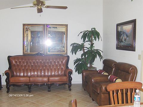 A cozy living room with leather furniture and decor.