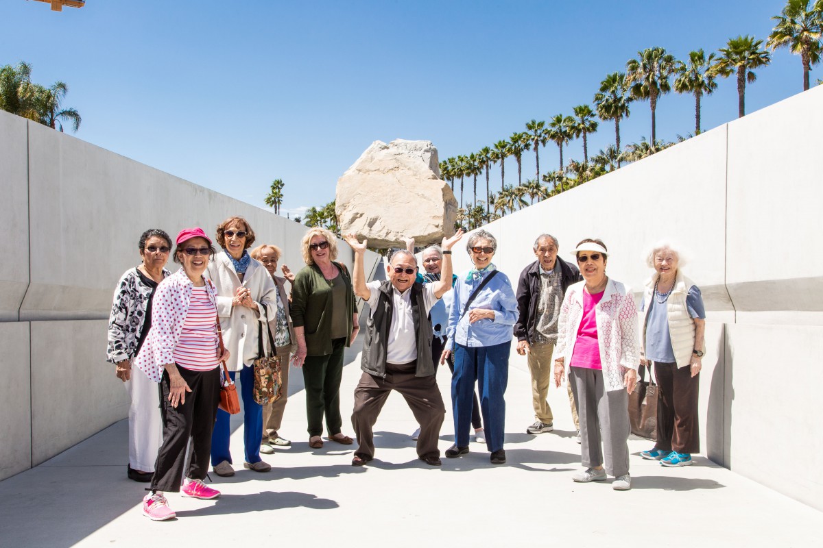 A group of people enjoying a sunny day at an outdoor art installation.