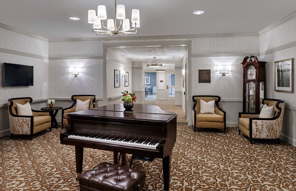 A stylish lobby featuring a grand piano and elegant seating area.
