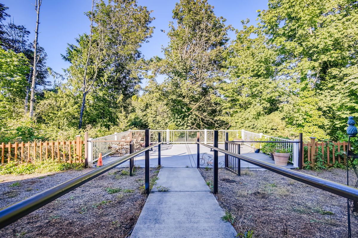 A scenic walkway surrounded by lush trees and nature.