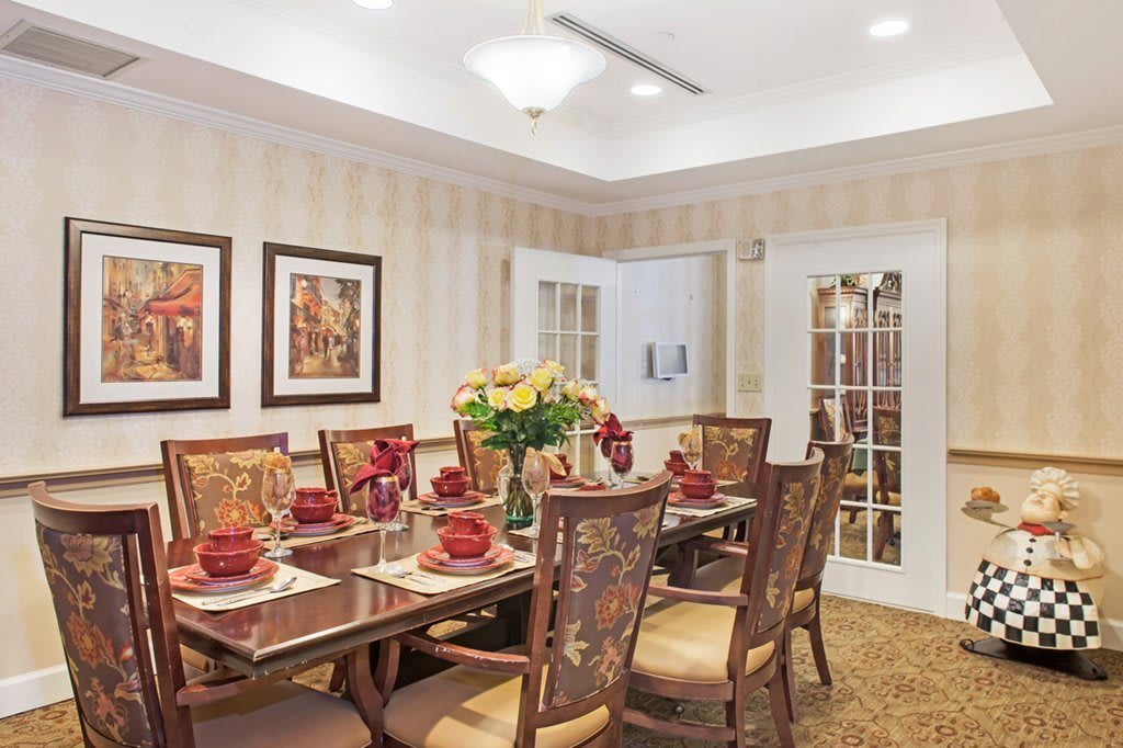 A well-decorated dining room with an elegant table setting and floral centerpiece.