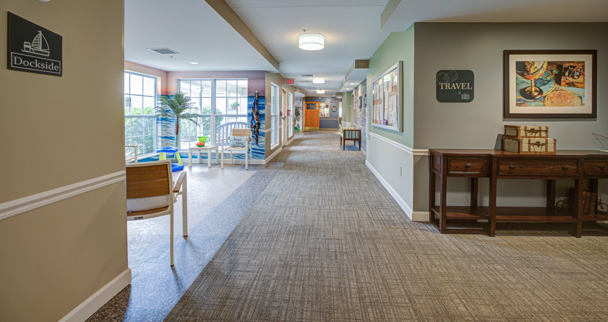 A well-lit hallway with chairs and decorative elements.