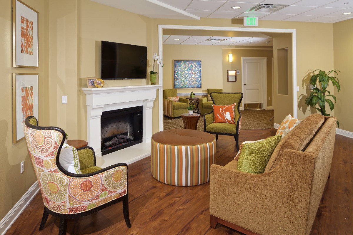 A cozy living room with comfortable seating, a fireplace, and a television.