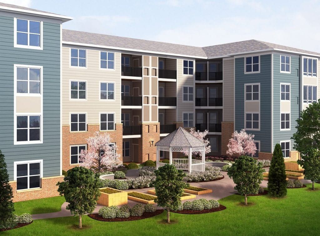 A modern apartment building with landscaped gardens and outdoor seating areas.