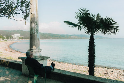 A serene moment by the water, enjoying the gentle breeze and beautiful scenery.
