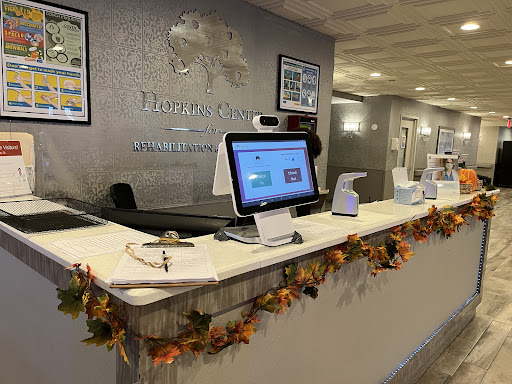 A welcoming reception area adorned with autumn decorations, featuring modern technology at the front desk.