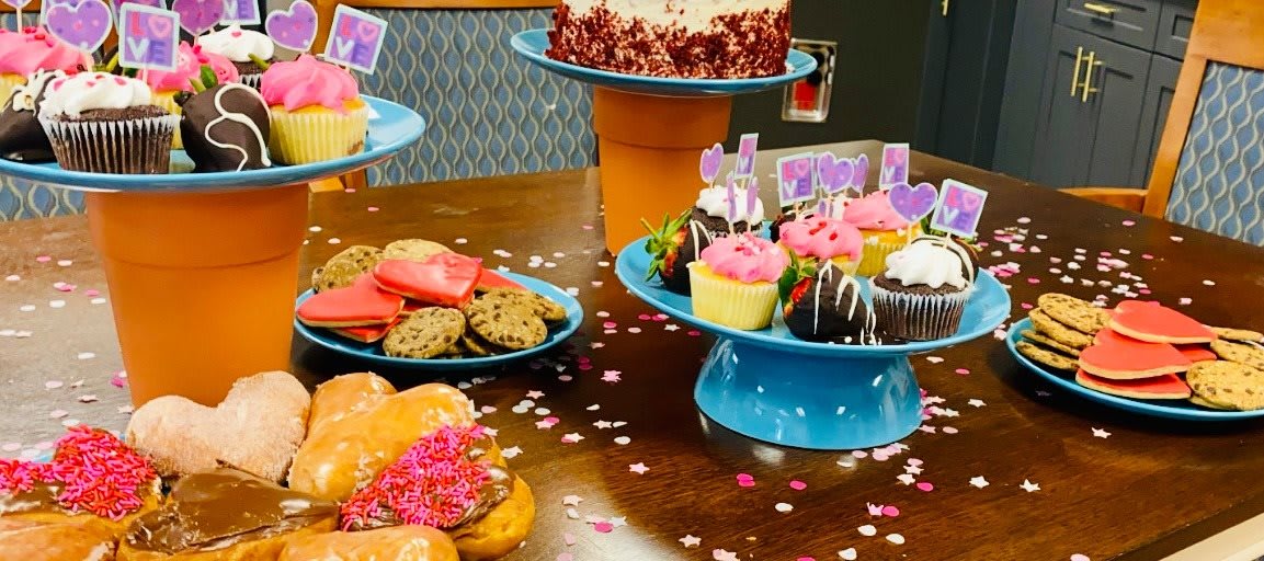 A festive table spread with cupcakes, cookies, and cake for a celebration.