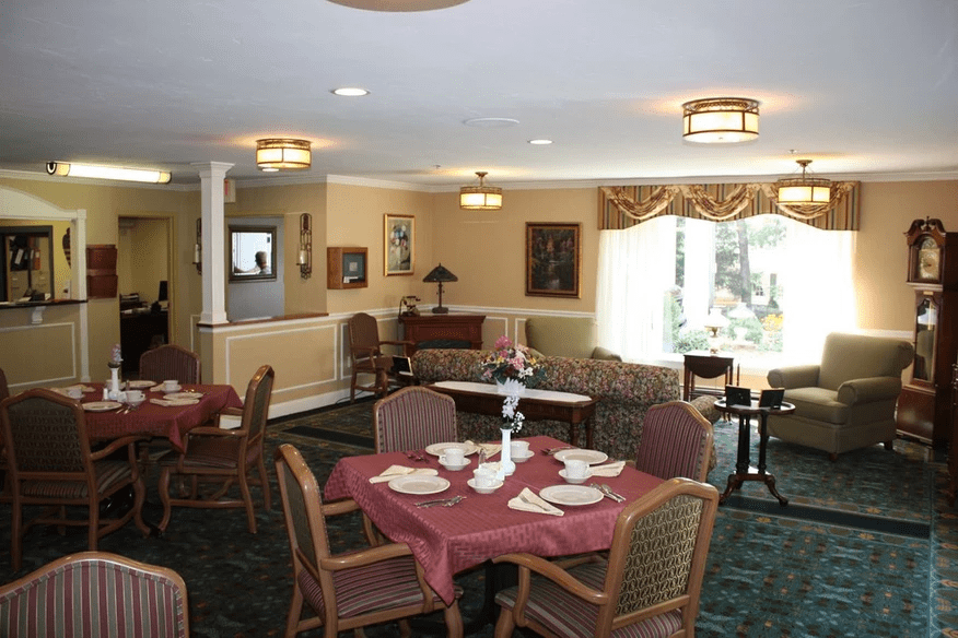 A cozy dining room with neatly arranged tables and chairs, set for guests.