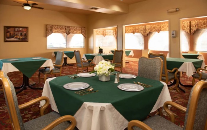 A cozy dining room with tables elegantly set for guests.