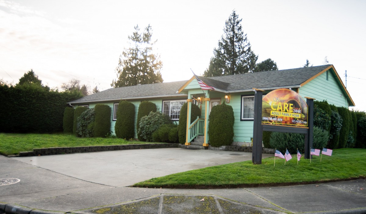 A restaurant building with a green exterior and a welcoming entrance, surrounded by trees.