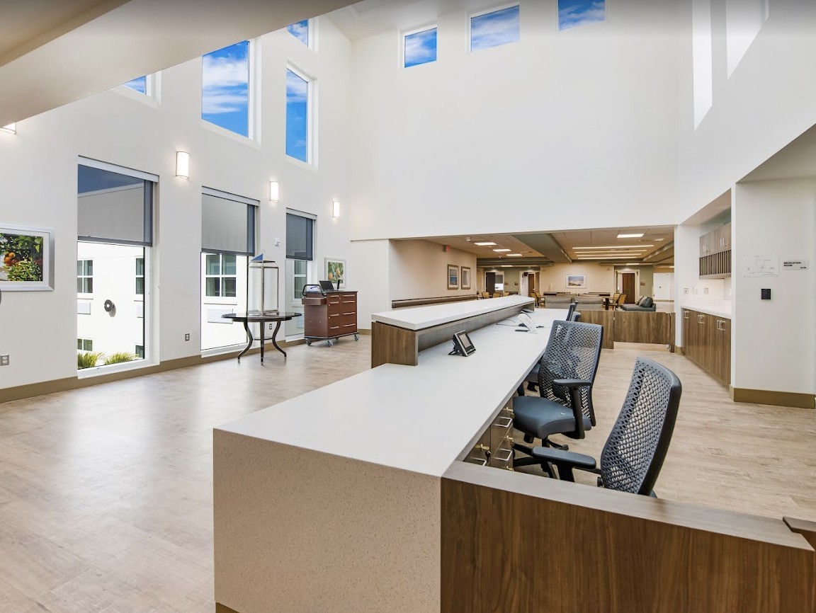 A modern and spacious office reception area with sleek furniture and large windows.