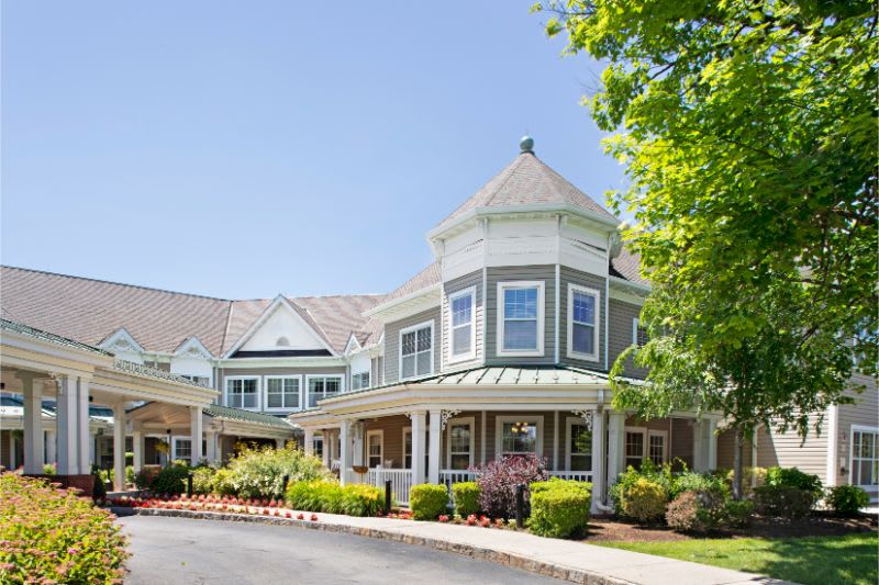 A charming residential building with a well-maintained garden and a sunny exterior.