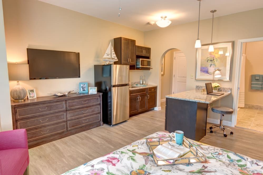A modern studio apartment featuring a kitchenette and cozy decor.