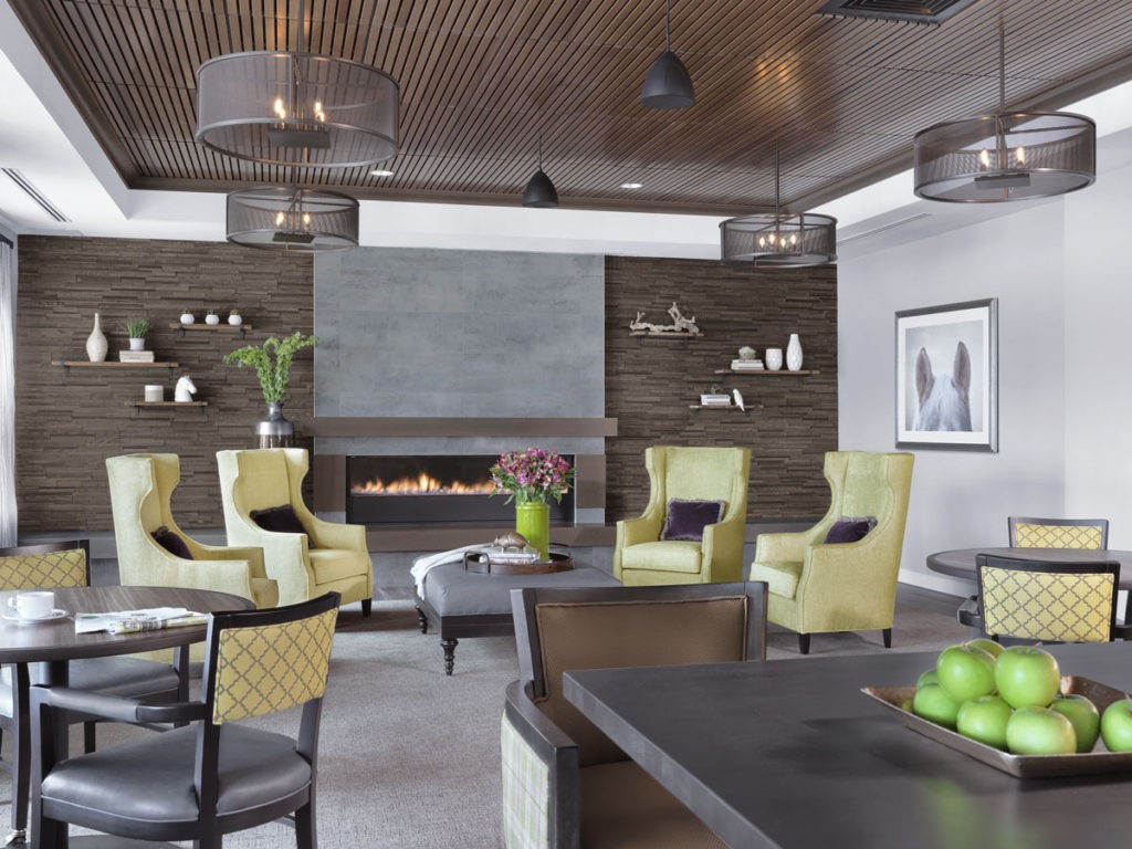 A modern living room with a fireplace, featuring stylish decor and comfortable seating.