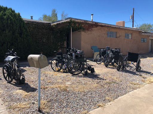 A residential area featuring a variety of vehicles parked on gravel.
