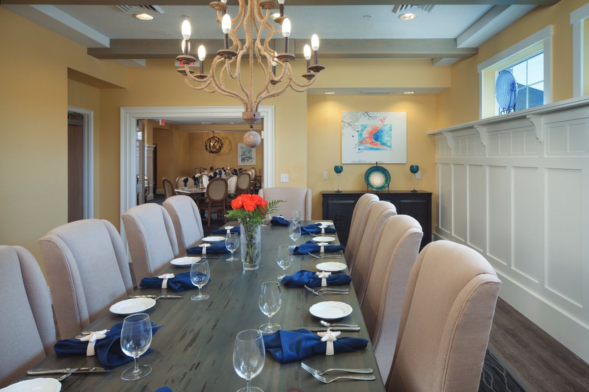 Elegant and formal dining room with a long table set for guests.