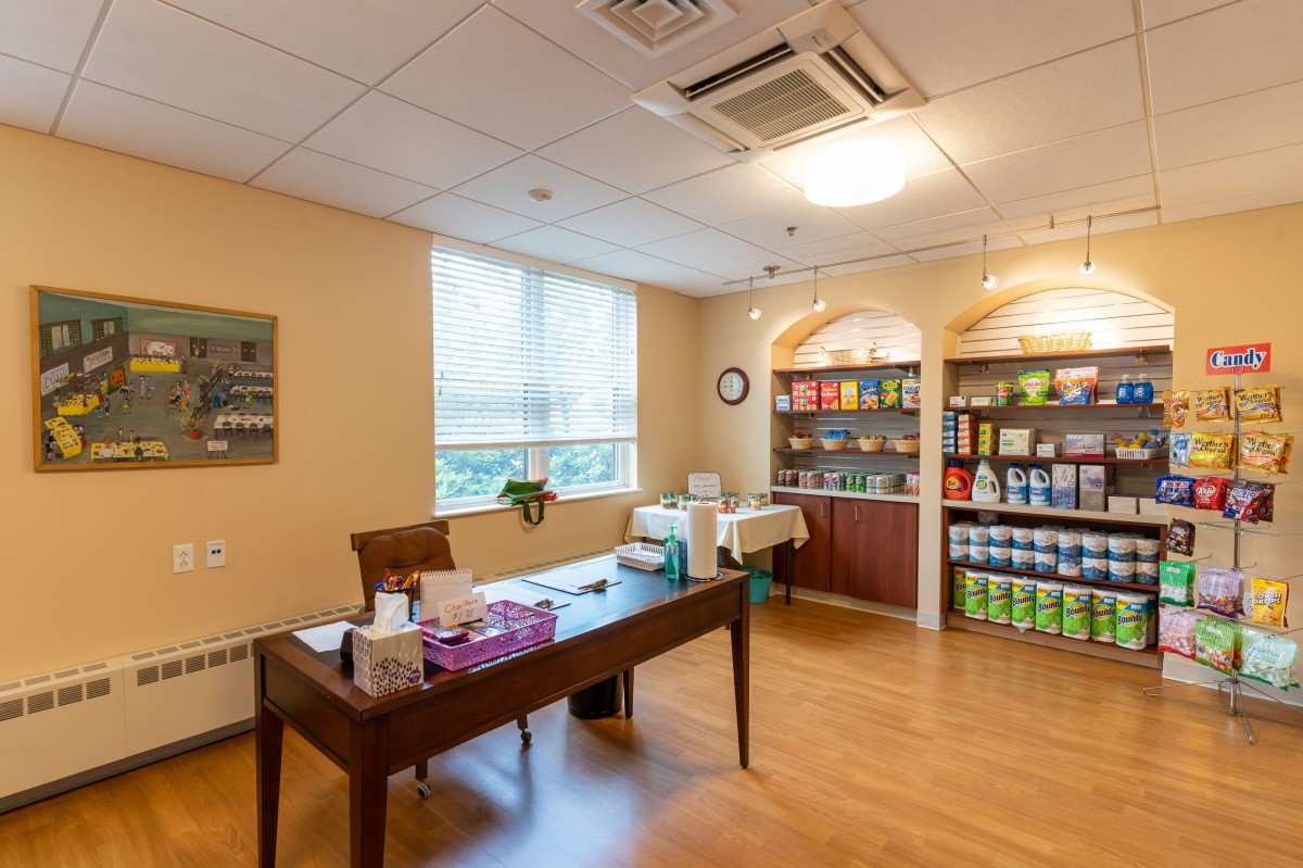 A well-organized office space featuring a desk and shelves stocked with various products.