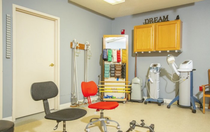 A well-organized medical office with various chairs and colorful equipment.