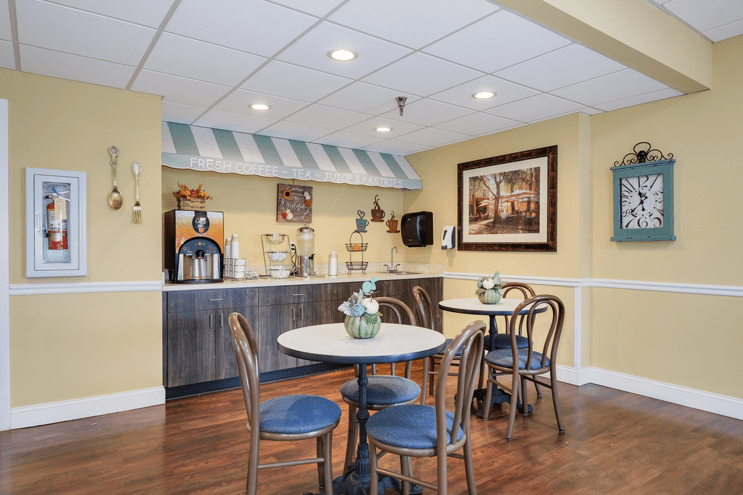A cozy cafe area with seating and a coffee station.