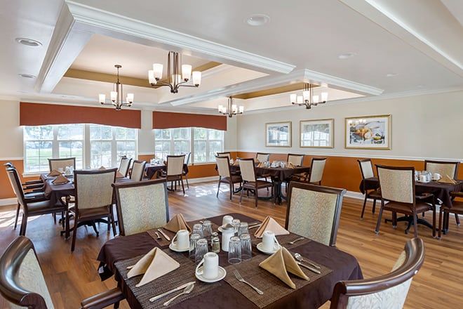 An elegant dining room setting with neatly arranged tables and chairs.