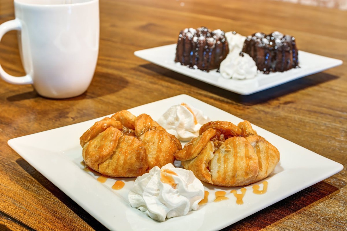 A delicious assortment of pastries and chocolate cake served with whipped cream.