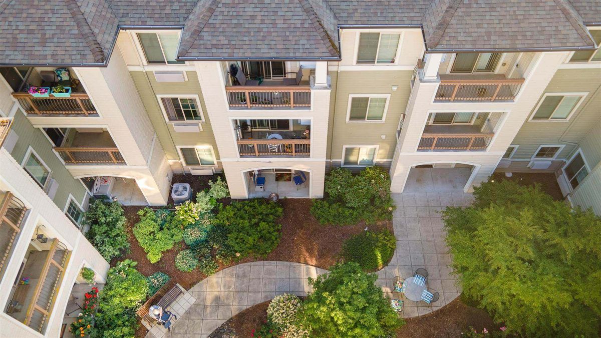 Aerial view of an apartment building with landscaped gardens and walkways.