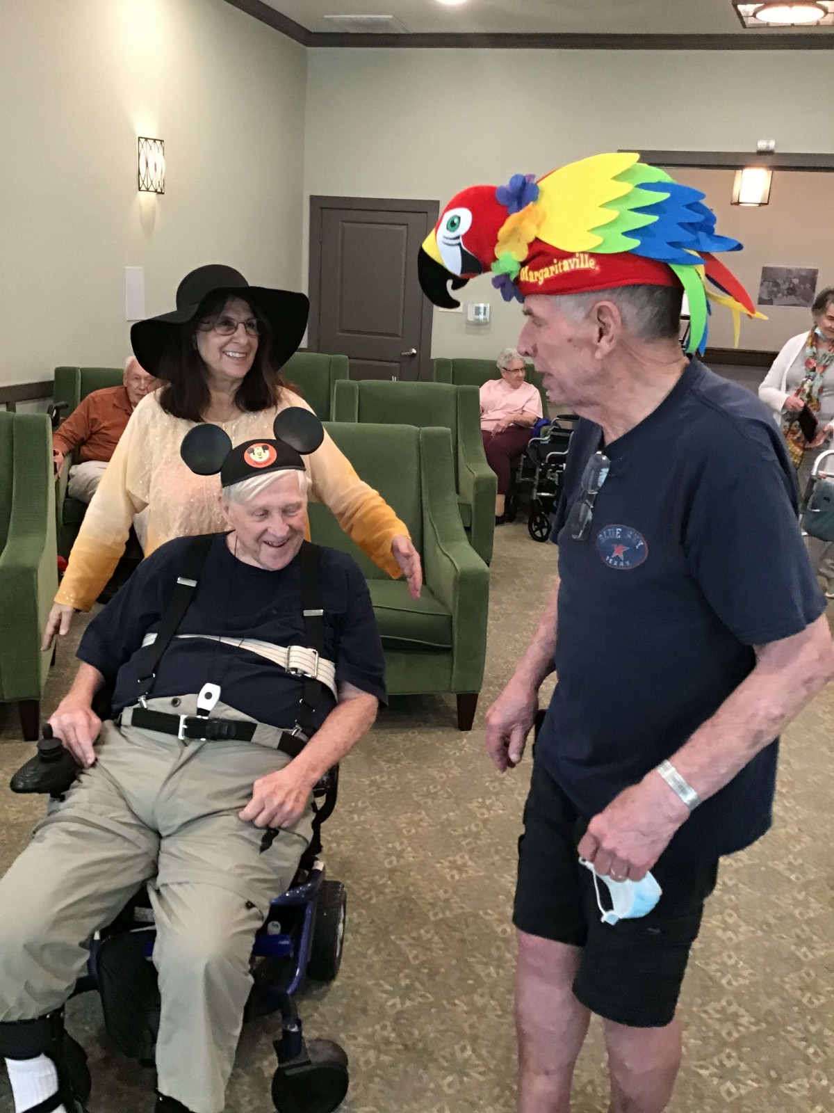 Elderly individuals enjoying a social gathering, wearing playful hats.