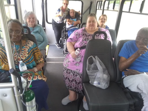 A group of senior citizens enjoying a bus ride together.