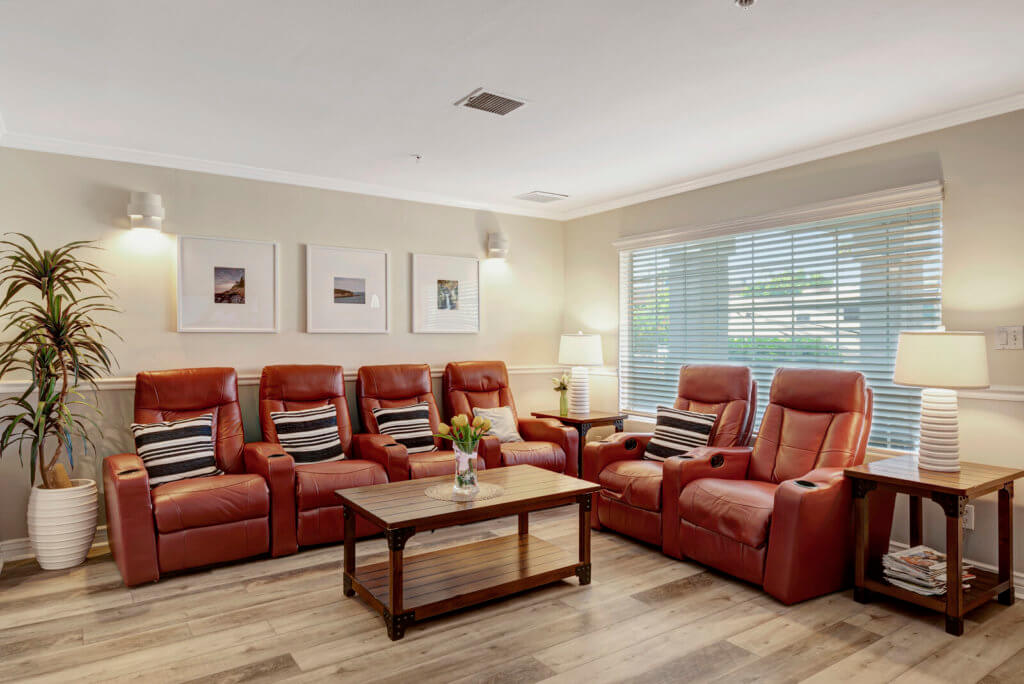 A cozy living room with red armchairs and a wooden coffee table.