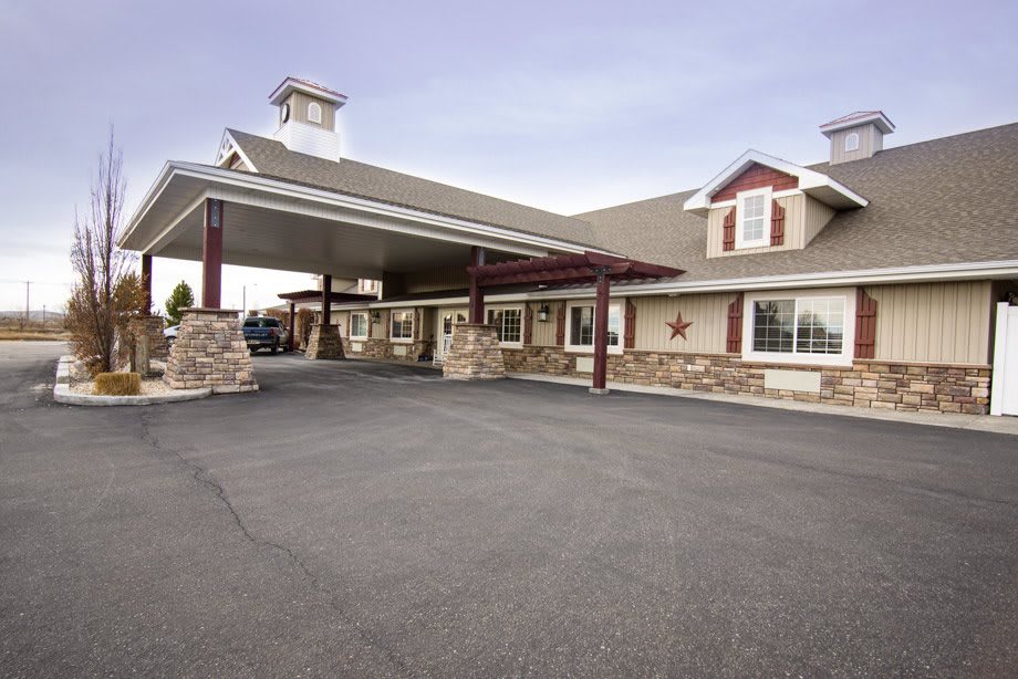 Exterior view of a hotel with a covered entrance and driveway.