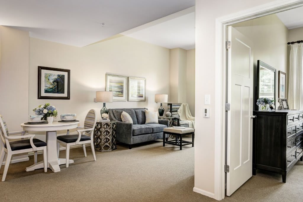 A cozy living room with an adjacent dining area, featuring stylish furniture and elegant decor.
