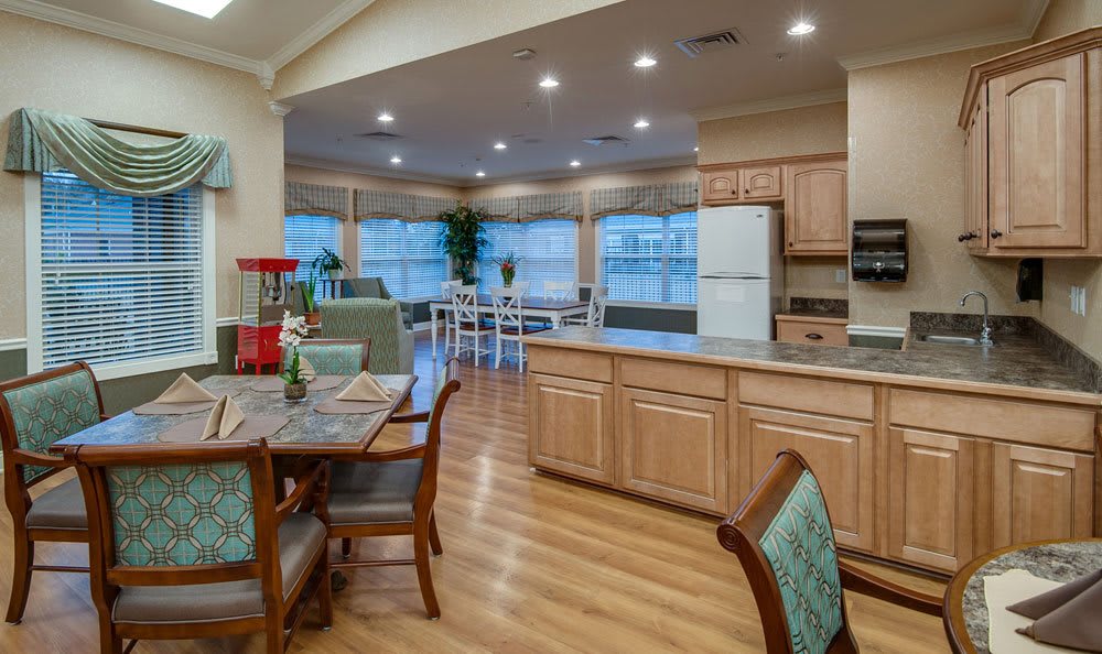 A spacious open-concept kitchen and dining area with wooden flooring and modern furnishings.