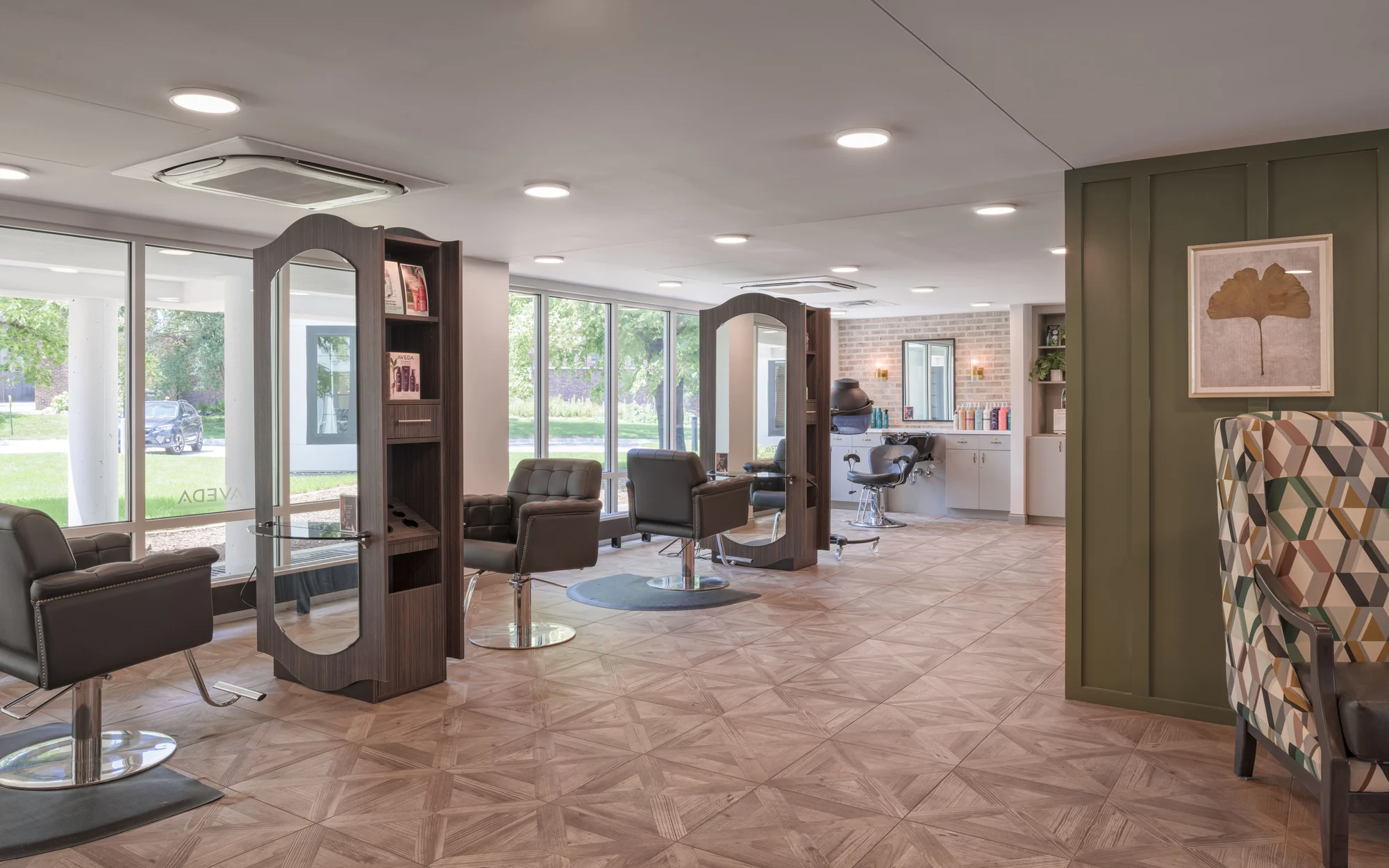 A modern salon with comfortable chairs and mirrors, featuring a stylish interior design.