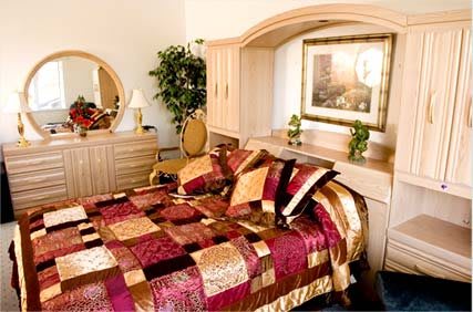 A stylish and colorful bedroom with elegant bedding and classic furniture.